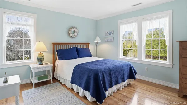 a bathroom with a toilet a sink a shower and a mirror