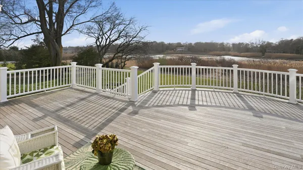 a view of balcony with wooden floor and outdoor seating