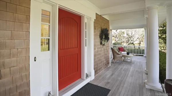 a view of a hallway with wooden floor and windows