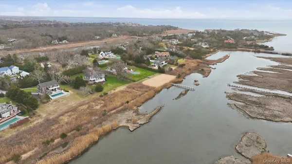 a view of a lake with beach and green space