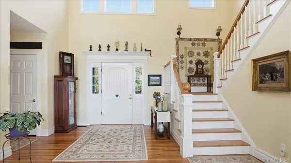 a view of entryway with furniture and wooden floor