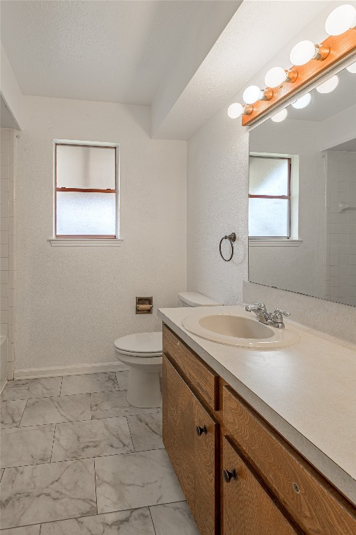 114 Timberline Drive Huntsville, TX 77320 - Photo 16 of 26 a bathroom with a granite countertop sink a toilet and a mirror