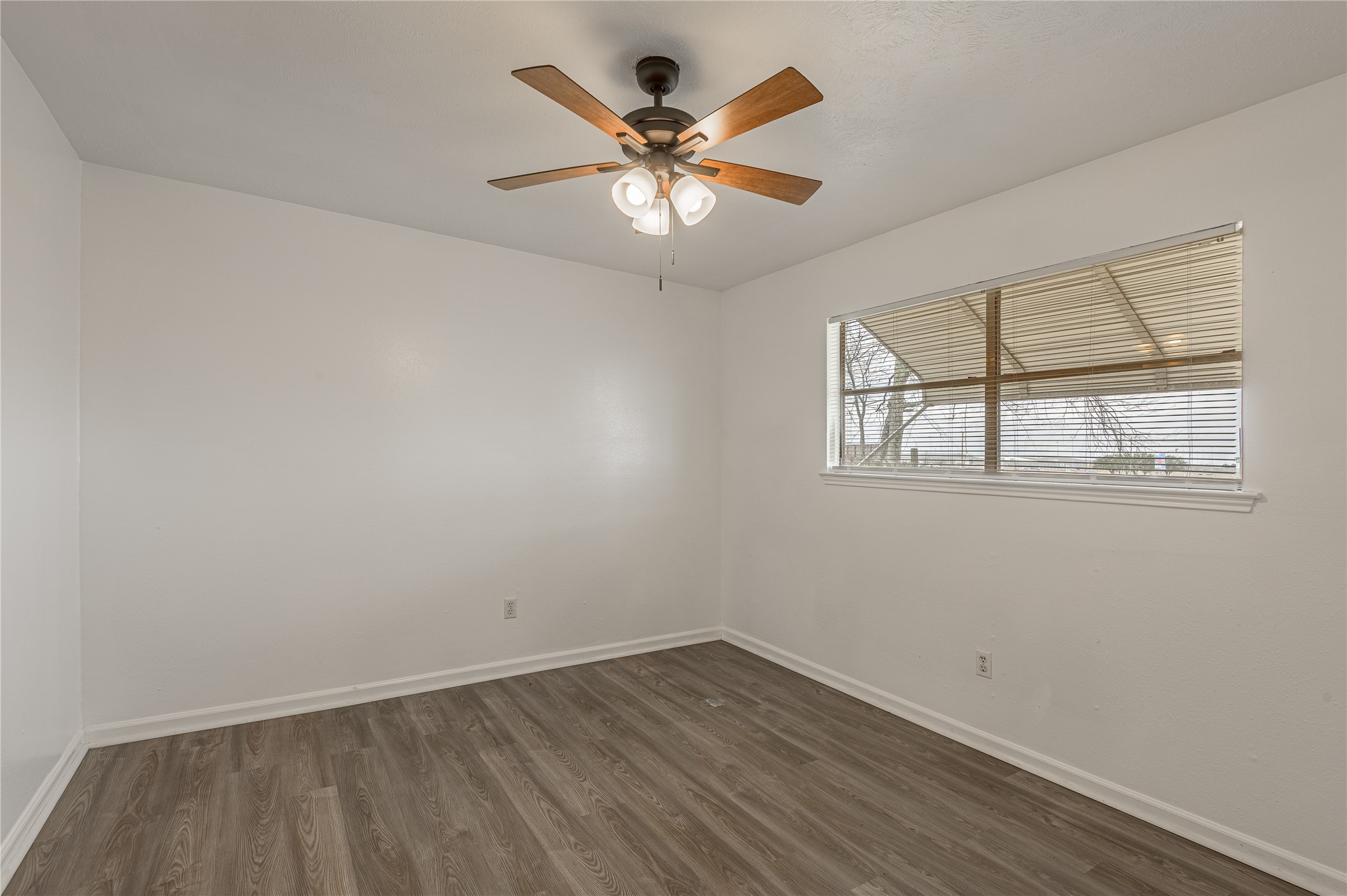 114 Timberline Drive Huntsville, TX 77320 - Photo 17 of 26 an empty room with wooden floor and windows