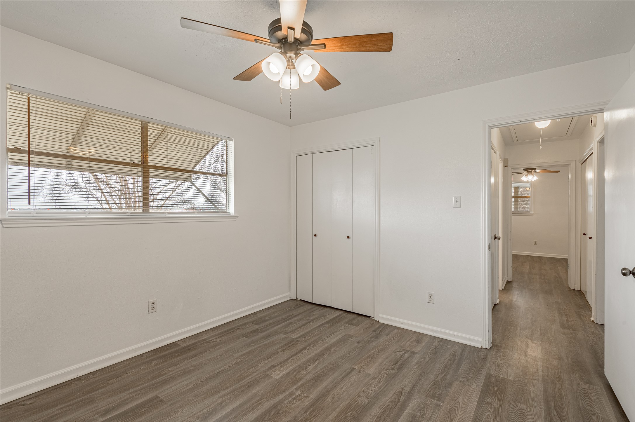 114 Timberline Drive Huntsville, TX 77320 - Photo 18 of 26 an empty room with wooden floor and windows