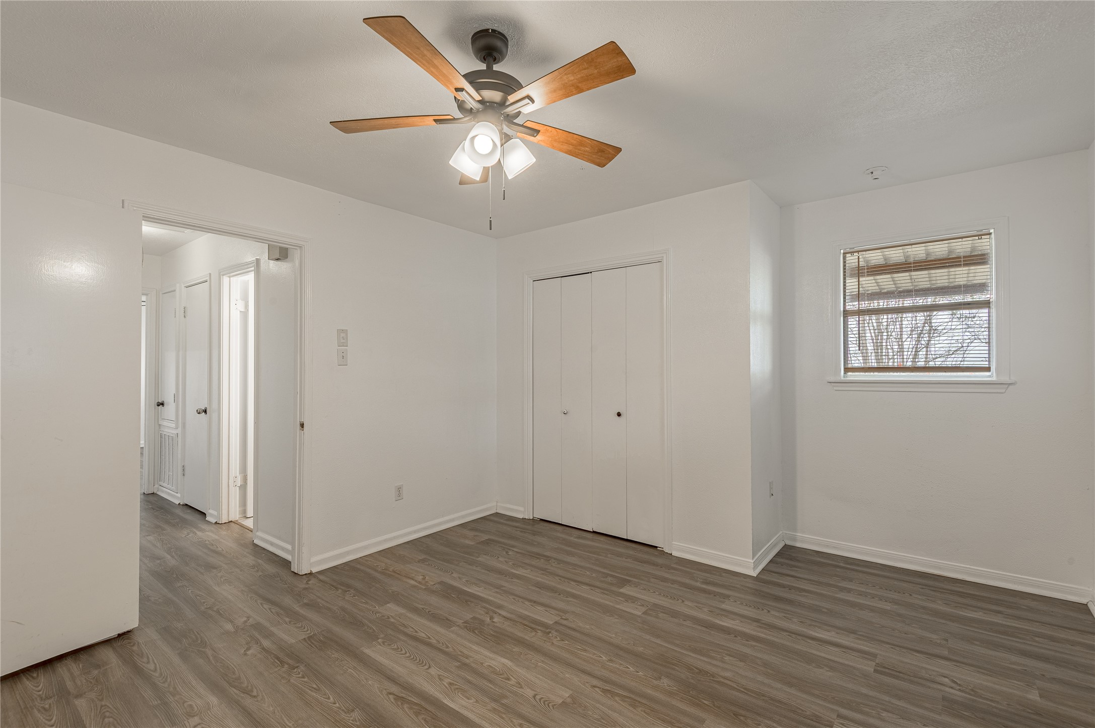 114 Timberline Drive Huntsville, TX 77320 - Photo 19 of 26 an empty room with wooden floor and ceiling fan