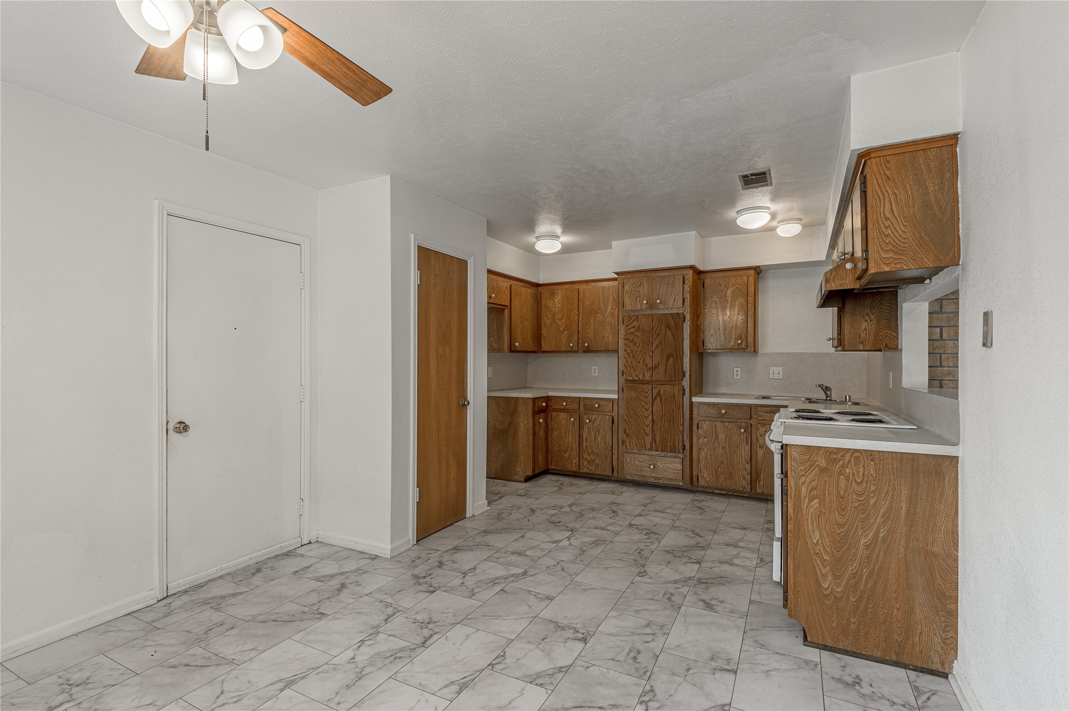 114 Timberline Drive Huntsville, TX 77320 - Photo 2 of 26 a kitchen with stainless steel appliances a refrigerator and a sink