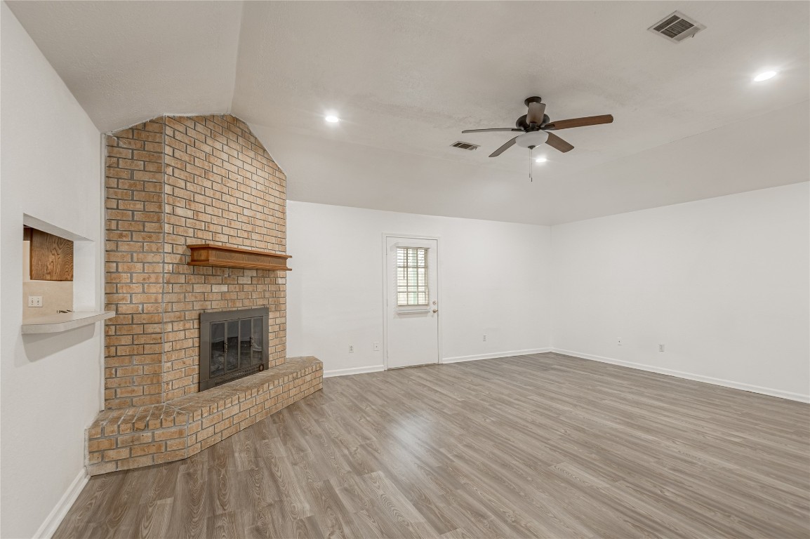 114 Timberline Drive Huntsville, TX 77320 - Photo 9 of 26 an empty room with windows fireplace and a sink