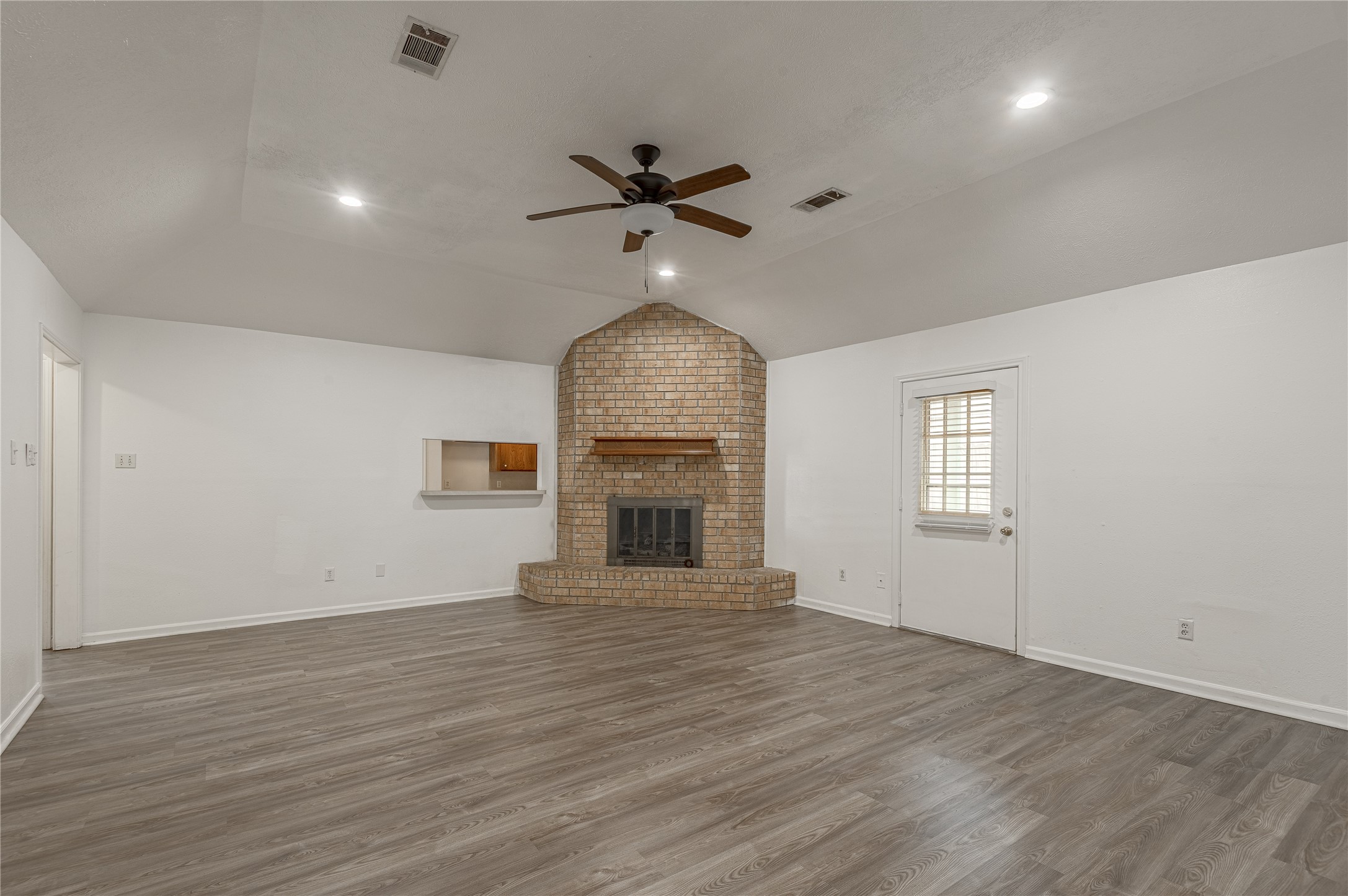 114 Timberline Drive Huntsville, TX 77320 - Photo 10 of 26 an empty room with wooden floor chandelier fan and windows
