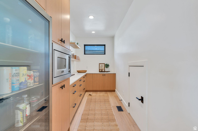 3918 South Mapleton Ests Drive Mapleton, UT 84664 - Photo 26 of 103 Kitchen featuring light wood finish cabinetry, open shelves, stainless steel microwave, recessed lighting, and light wood-type flooring