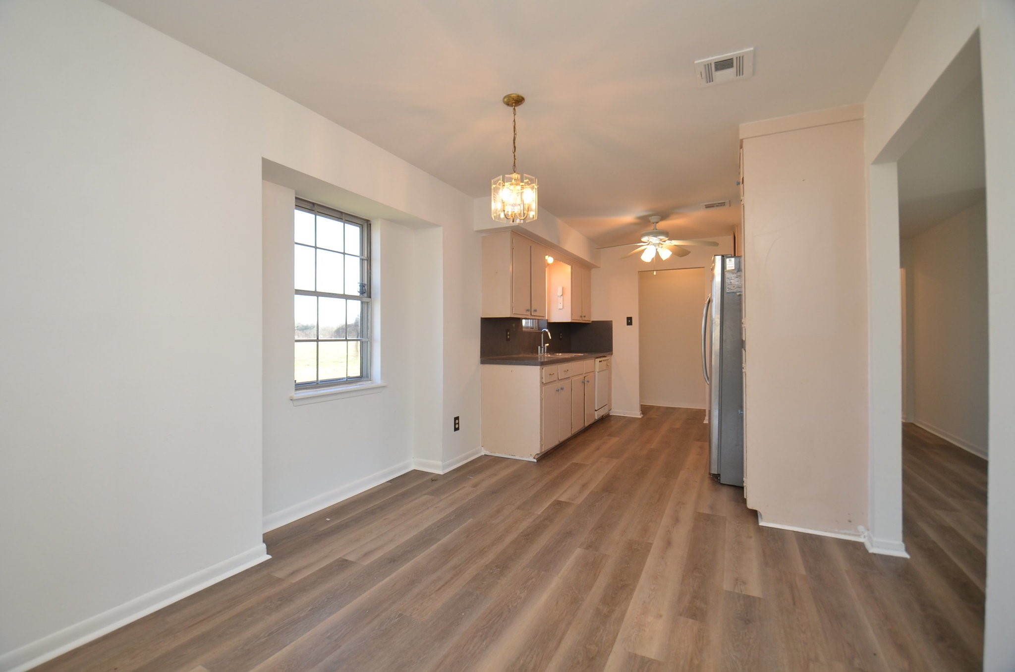 15573 Farm To Market 1887 Hempstead, TX 77445 - Photo 13 of 50 a view of a kitchen with a sink a refrigerator and wooden floor