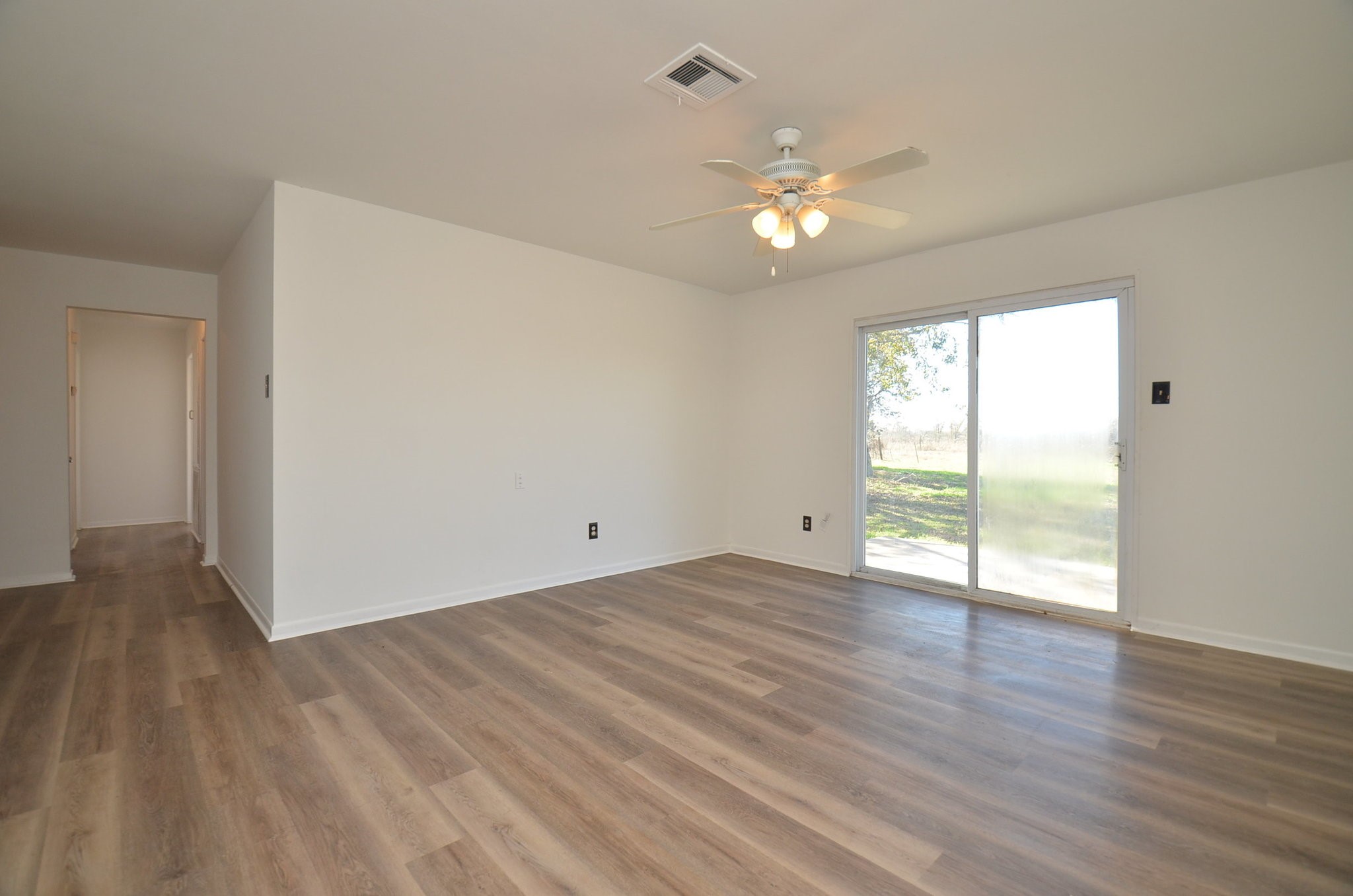 15573 Farm To Market 1887 Hempstead, TX 77445 - Photo 19 of 50 a view of an empty room with wooden floor and a window