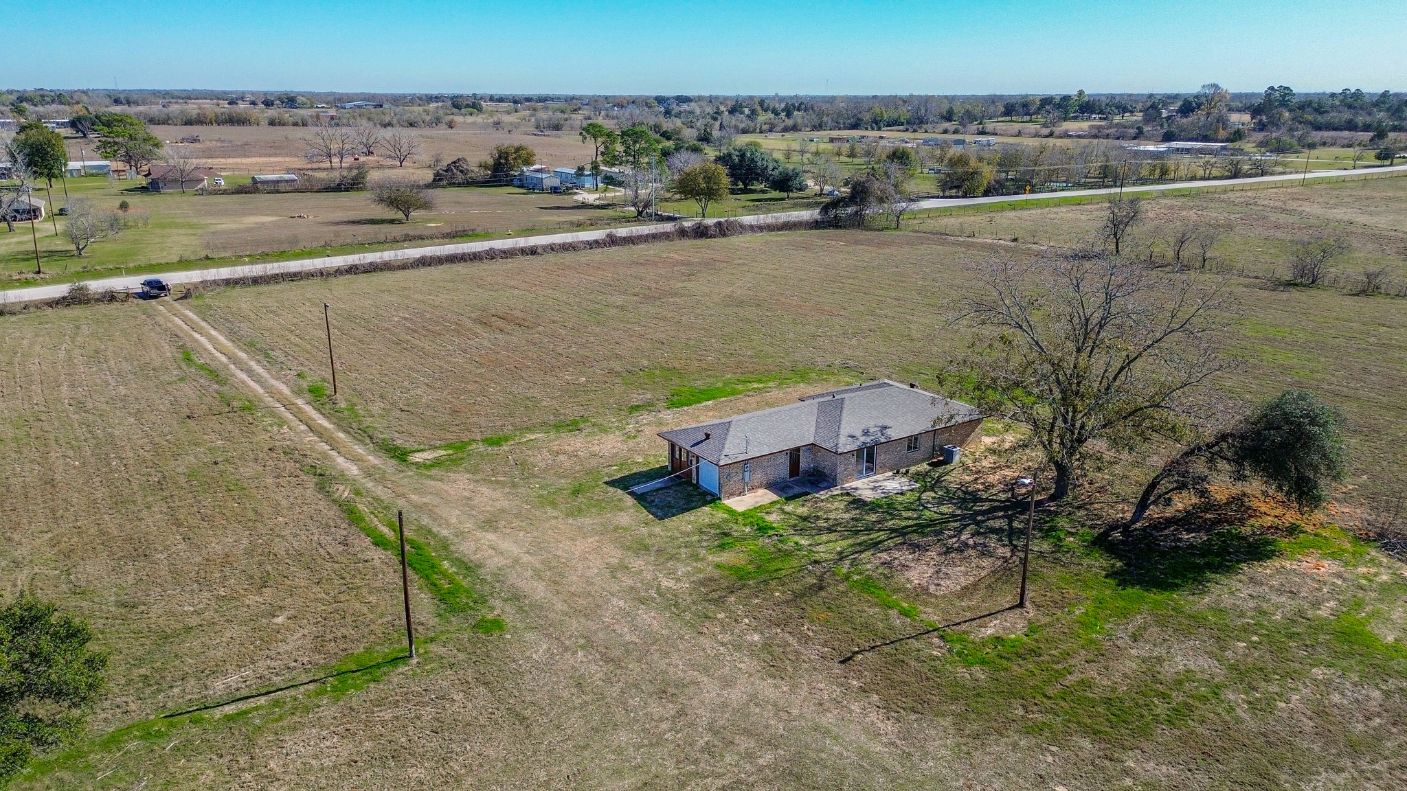 15573 Farm To Market 1887 Hempstead, TX 77445 - Photo 9 of 50 an aerial view of a house with a lake view