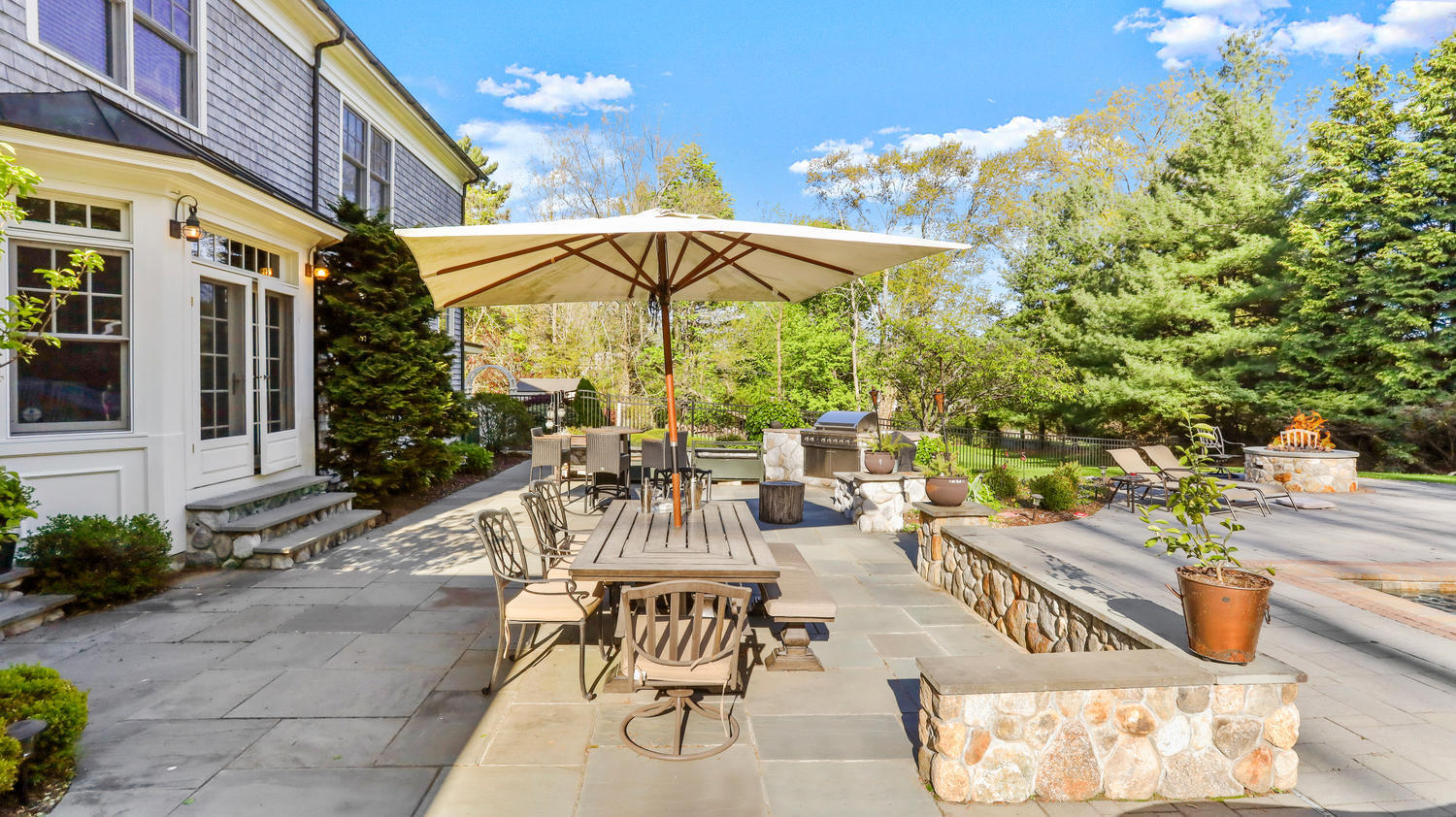 8 Wakeman Road Westport, CT 06880 - Photo 34 of 41 a view of a patio with table and chairs under an umbrella