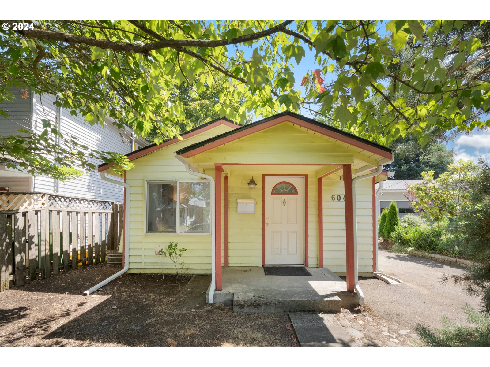 604 Northeast 93rd Avenue Portland, OR 97220 - Photo 1 of 34 a front view of a house with a yard