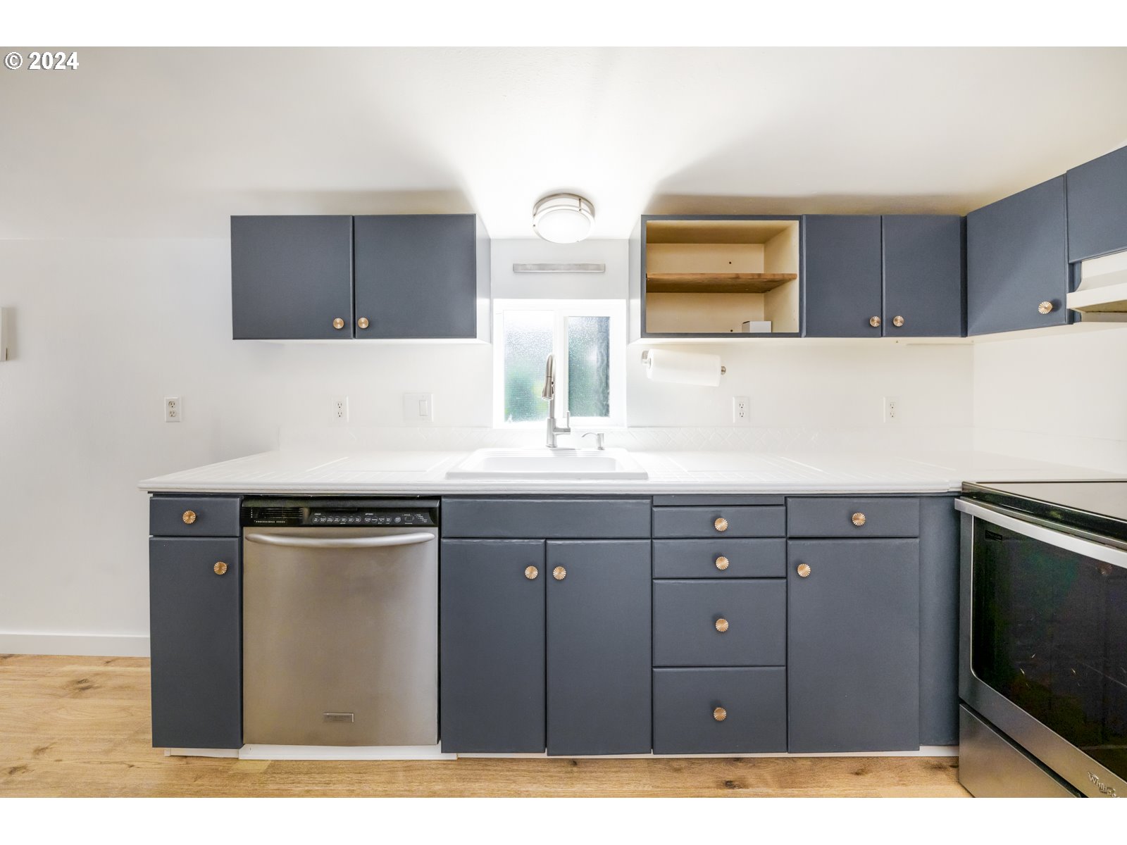 604 Northeast 93rd Avenue Portland, OR 97220 - Photo 14 of 34 a kitchen with a sink and a microwave