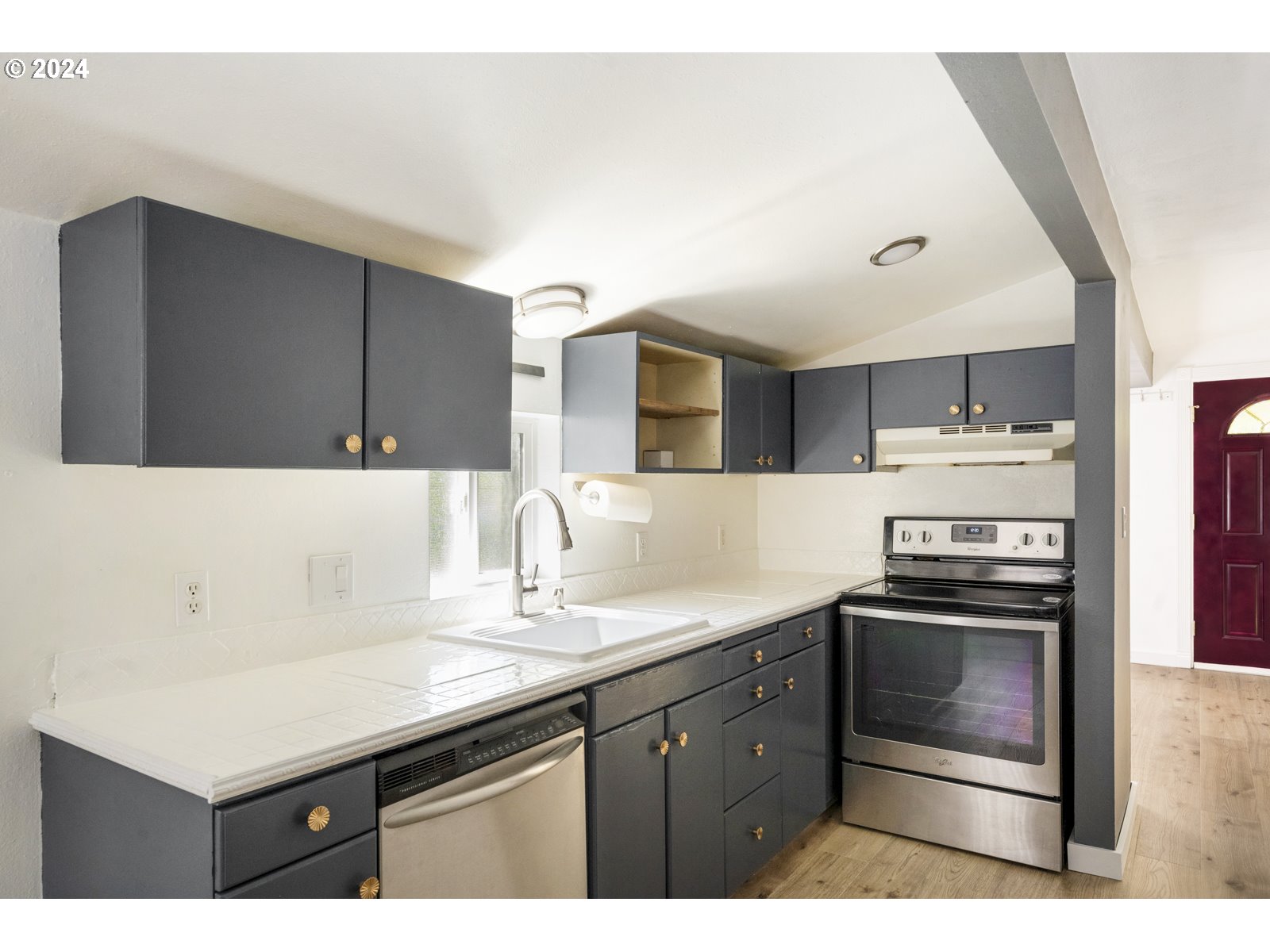 604 Northeast 93rd Avenue Portland, OR 97220 - Photo 15 of 34 a kitchen with a sink and cabinets