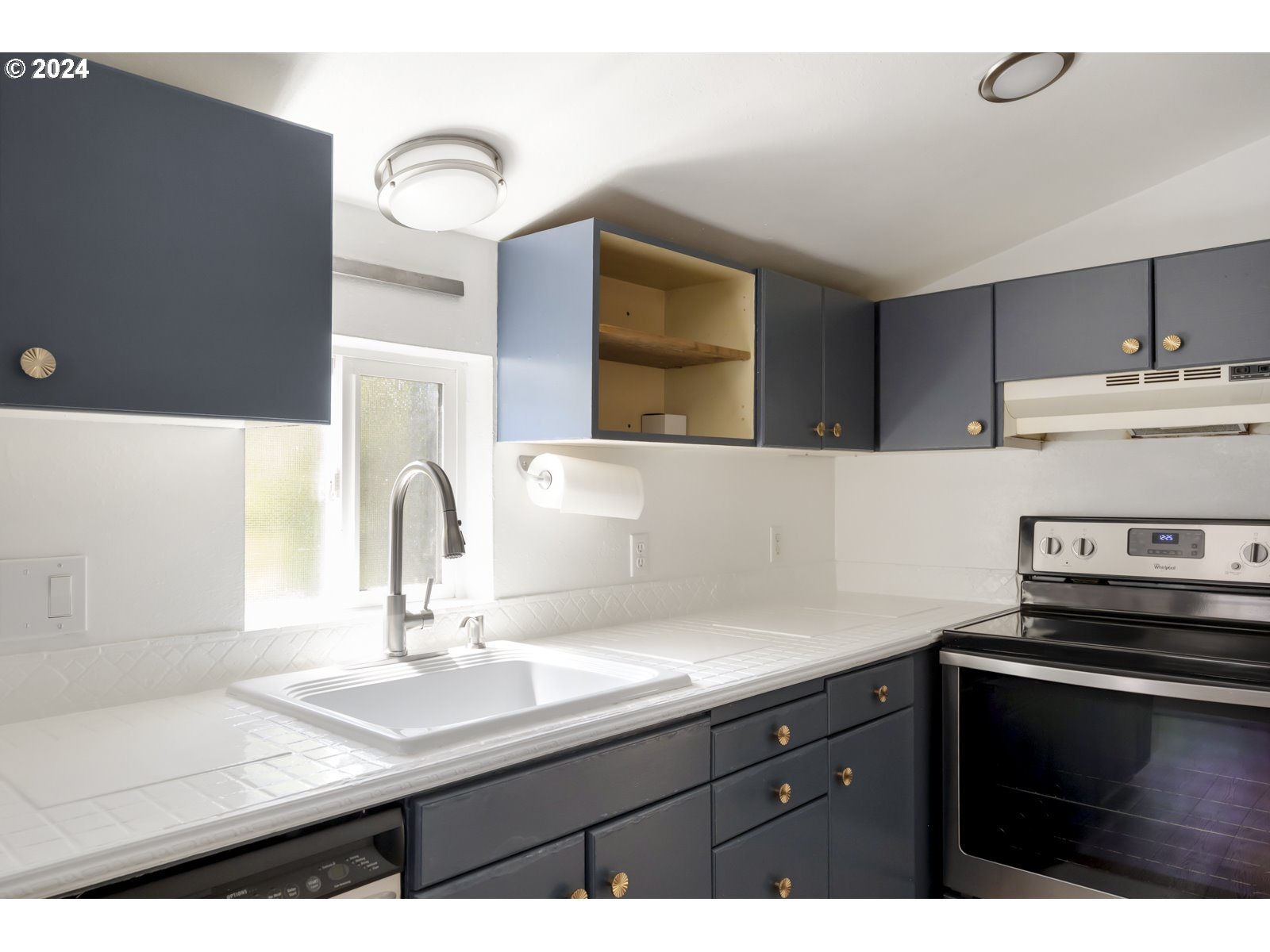604 Northeast 93rd Avenue Portland, OR 97220 - Photo 16 of 34 a kitchen with a sink and cabinets