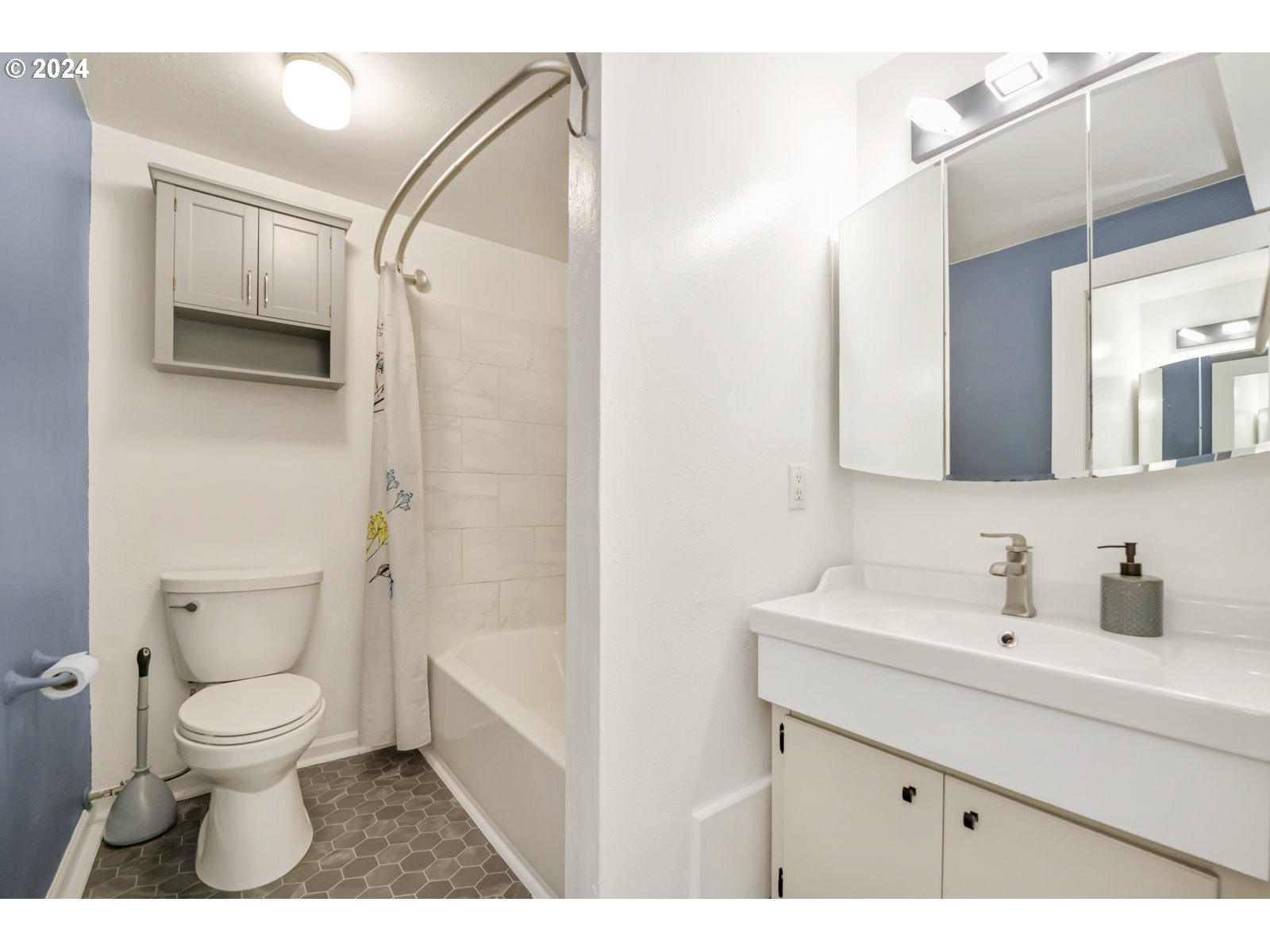 604 Northeast 93rd Avenue Portland, OR 97220 - Photo 21 of 34 a bathroom with a sink a toilet and a mirror