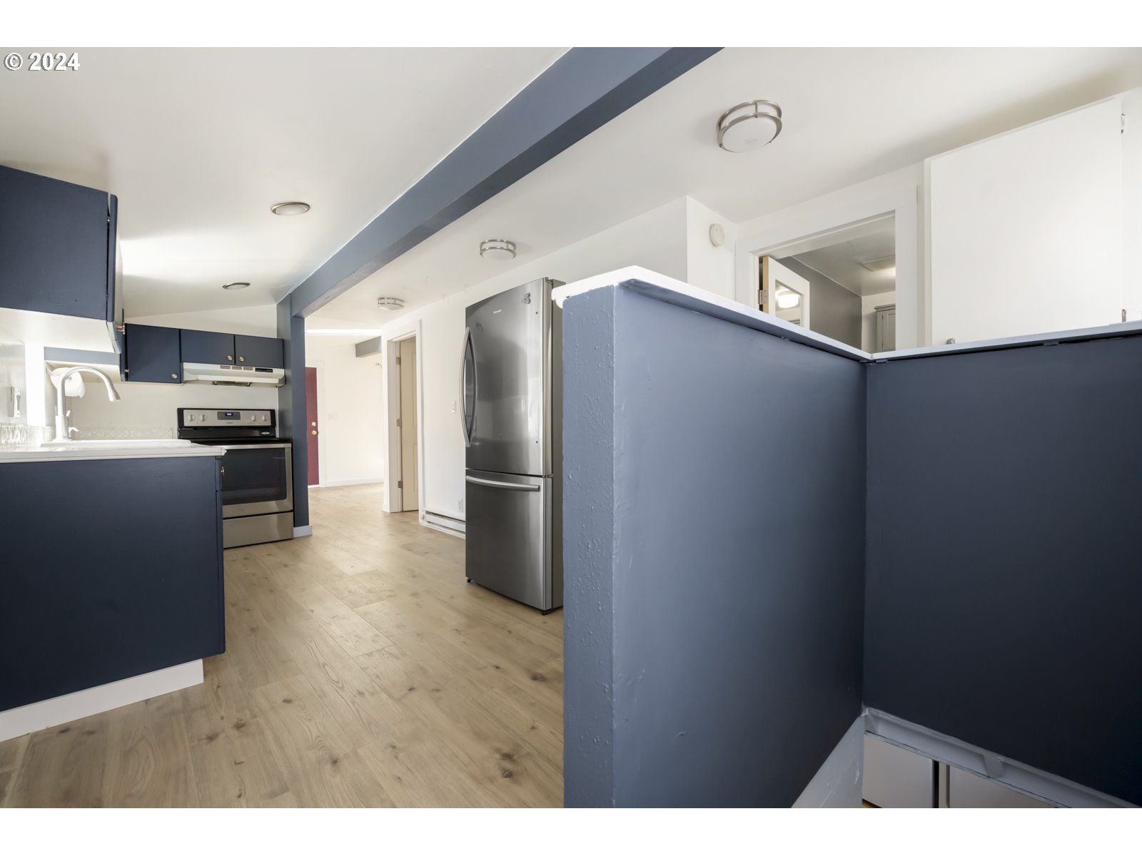 604 Northeast 93rd Avenue Portland, OR 97220 - Photo 23 of 34 a kitchen with stainless steel appliances a refrigerator and a stove