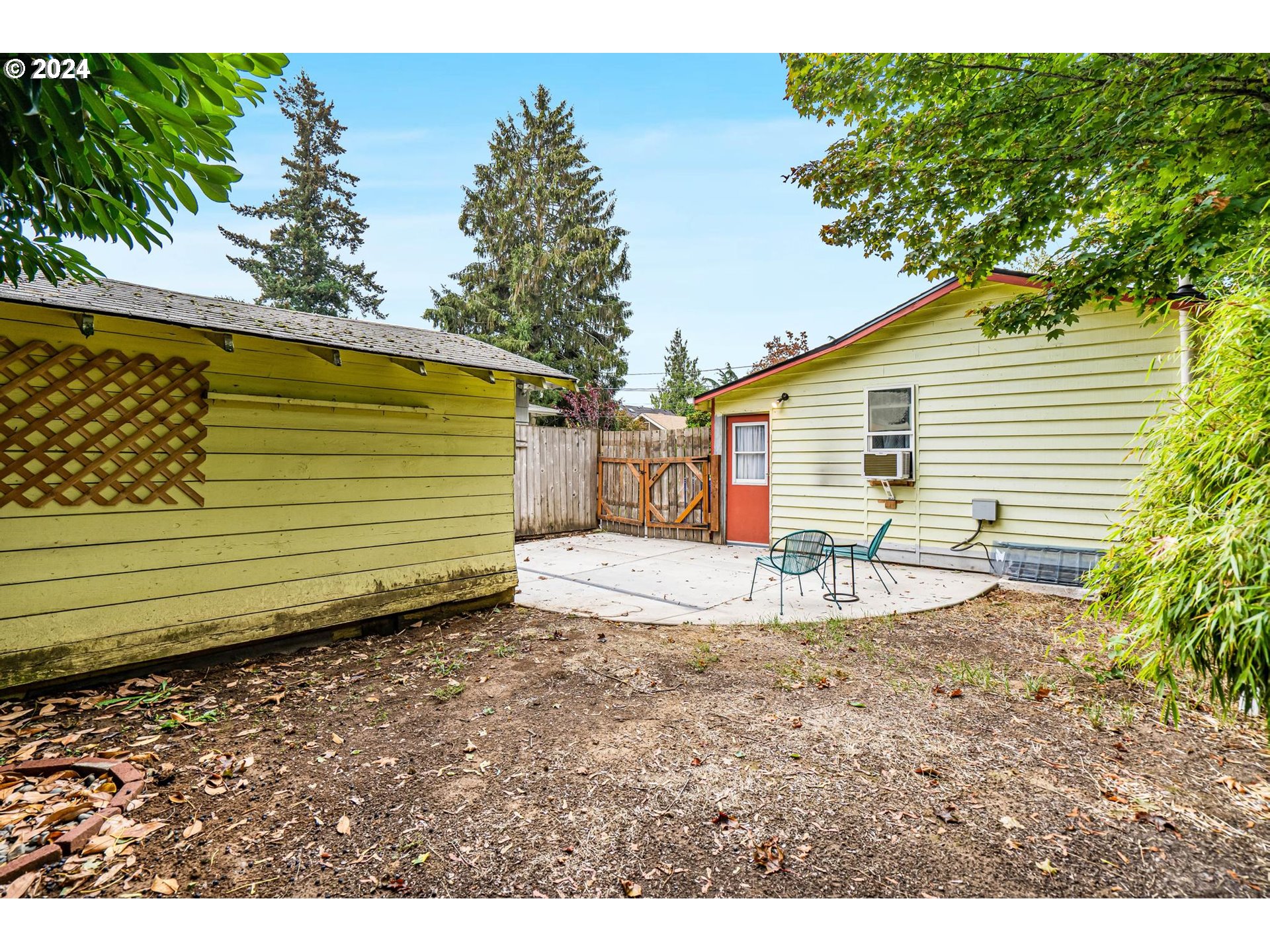 604 Northeast 93rd Avenue Portland, OR 97220 - Photo 32 of 34 a view of a backyard with a house and a garden