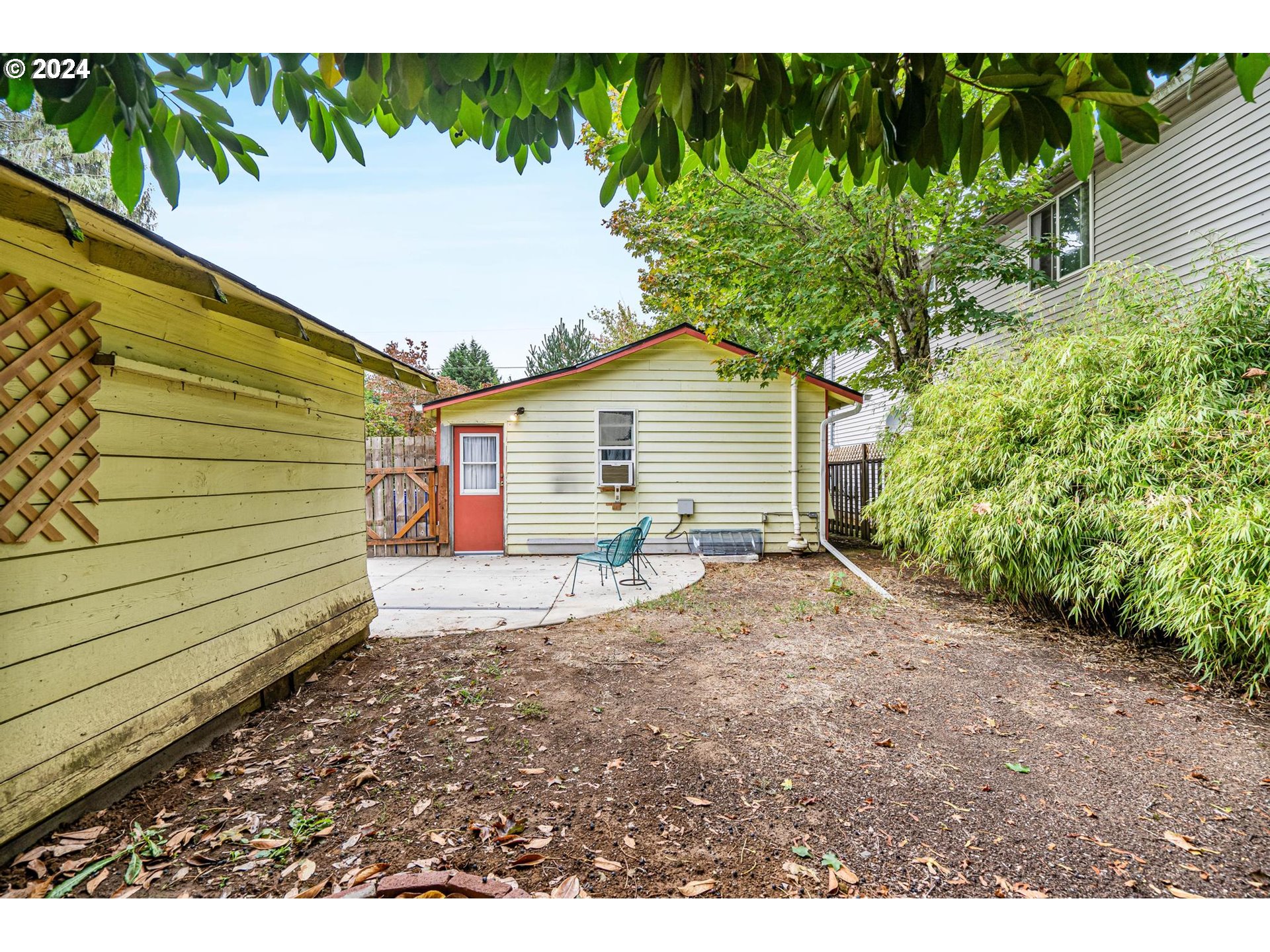 604 Northeast 93rd Avenue Portland, OR 97220 - Photo 33 of 34 a view of a backyard with plants and large trees