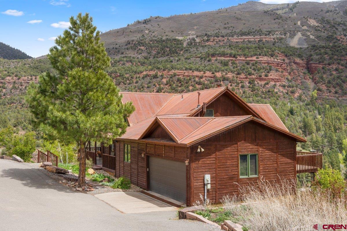 2490 County Road 17 Ridgway, CO 81432 - Photo 3 of 26 a house with trees in the background