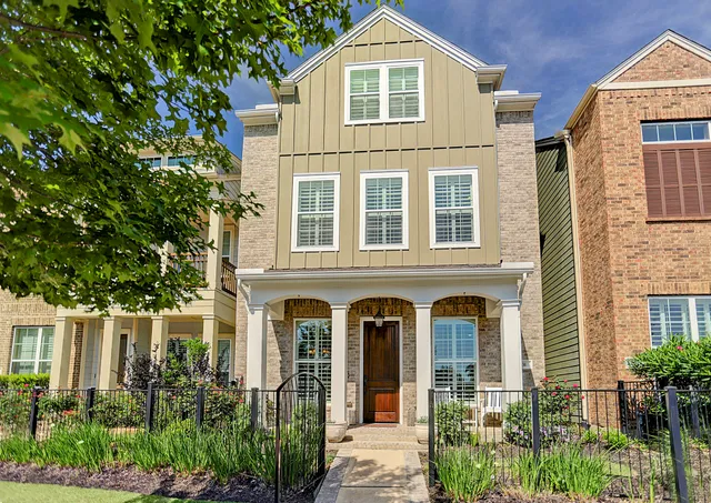 front view of a brick house with a large windows