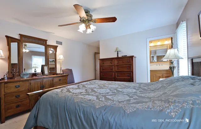 a bedroom with a bed and a dresser