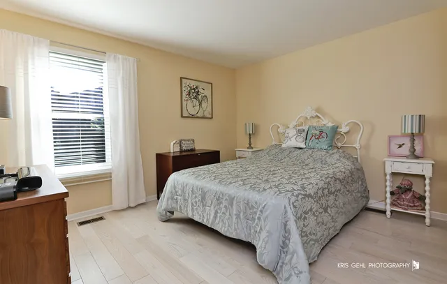 a spacious bedroom with a bed and a window