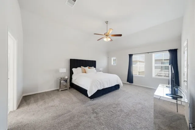 a bedroom with a bed and window