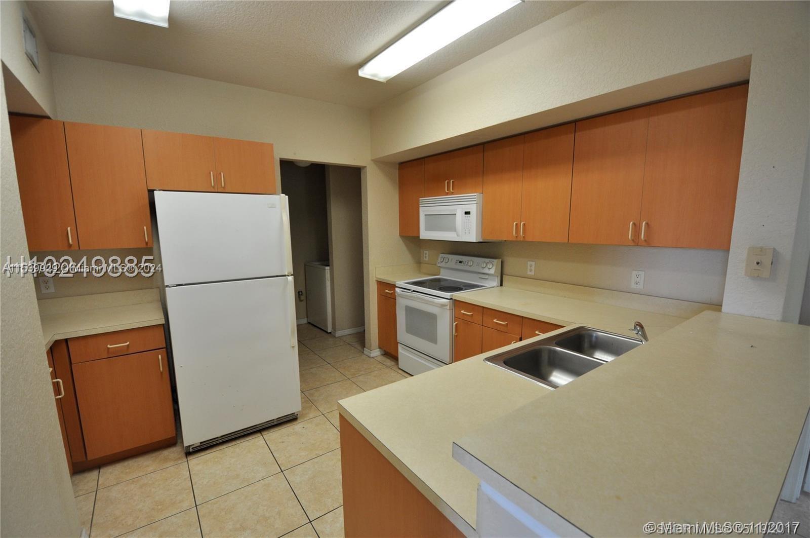 a kitchen with stainless steel appliances a refrigerator sink and stove