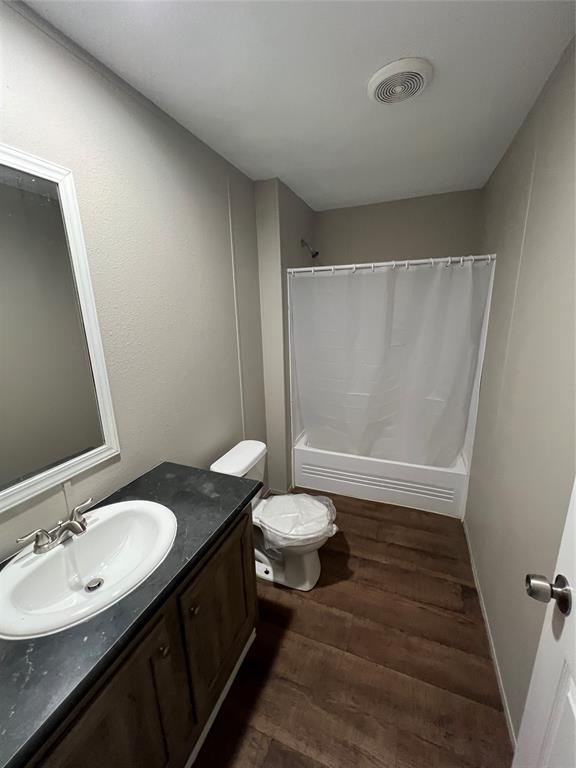 197 Sweden Street Walnut Springs, TX 76690 - Photo 13 of 27 a bathroom with a double vanity sink toilet and a mirror