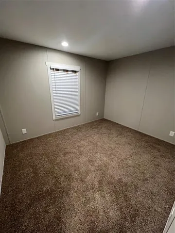 an empty room with a empty space and windows