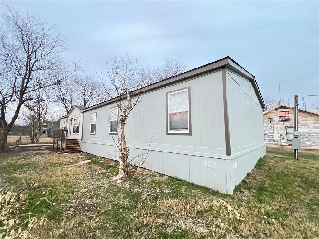 197 Sweden Street Walnut Springs, TX 76690 - Photo 2 of 27 a front view of a house with a yard