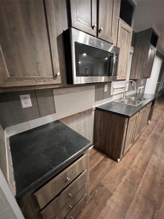 197 Sweden Street Walnut Springs, TX 76690 - Photo 10 of 27 a kitchen with stainless steel appliances a stove microwave and sink