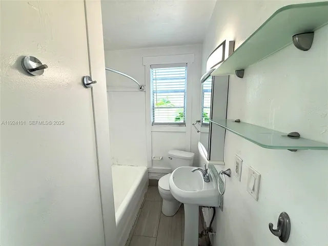 a bathroom with a sink and mirror