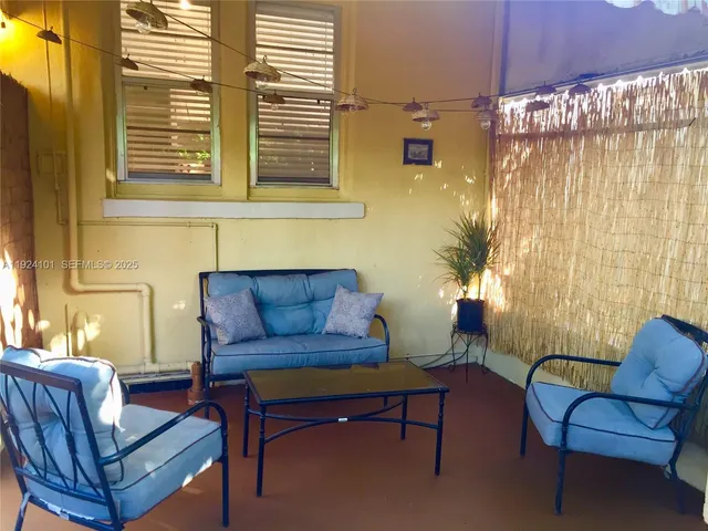 a view of a swimming pool with an outdoor space and seating area