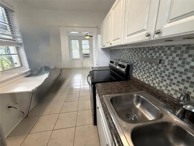 a kitchen with a sink and cabinets