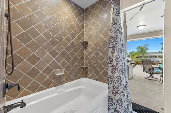 a bathroom with a bathtub and shower