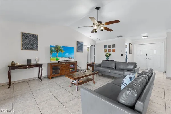 a living room with furniture and a ceiling fan