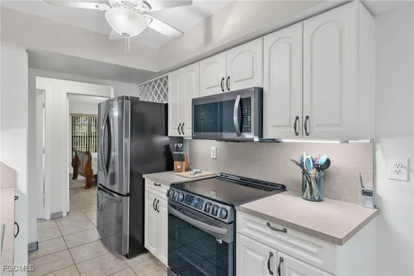 a kitchen with stainless steel appliances a refrigerator sink and cabinets