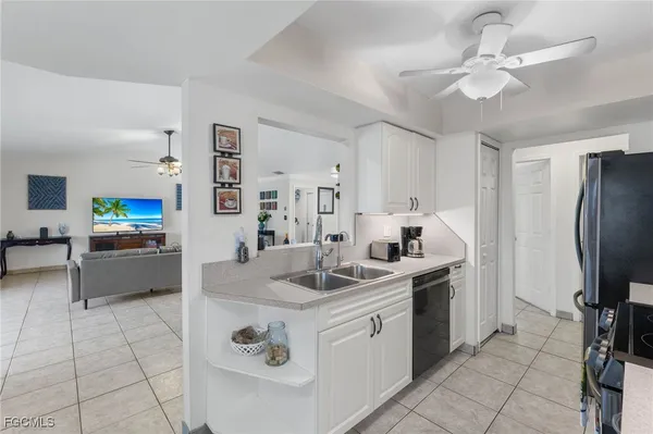 a kitchen with stainless steel appliances granite countertop a sink and a refrigerator
