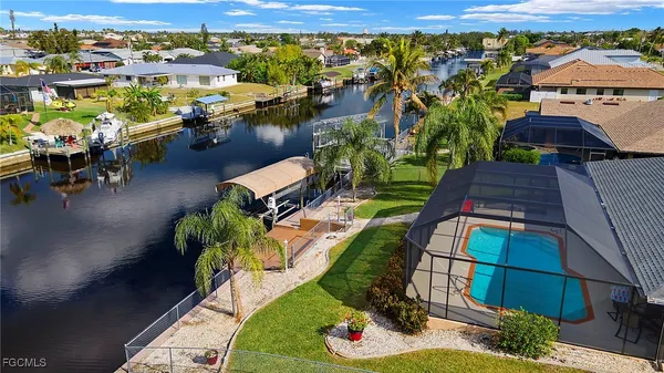 an aerial view of a house with garden space and lake view