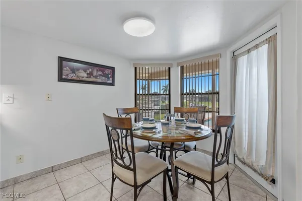 a view of a dining room with furniture and window