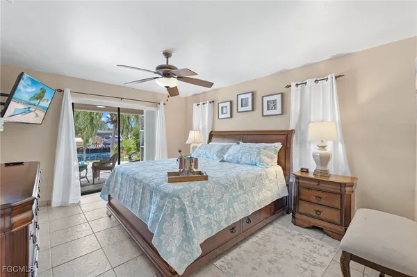 a bedroom with a bed a dresser next to a window