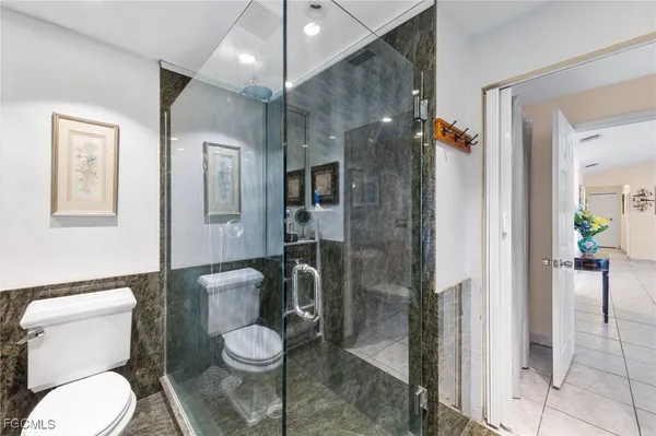 a white toilet sitting next to a bathroom sink