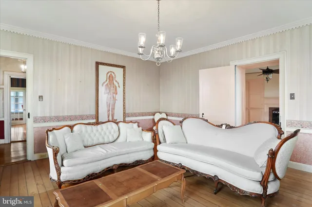 a kitchen with stainless steel appliances a stove a sink dishwasher a stove a refrigerator with white cabinets and wooden floor