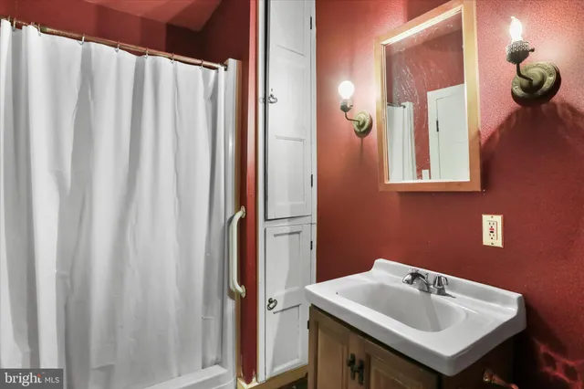 a front view of a house with a yard and potted plants