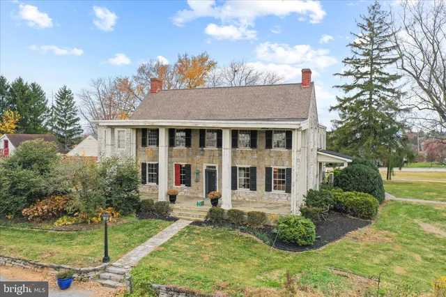 a front view of a house with a yard and pathway
