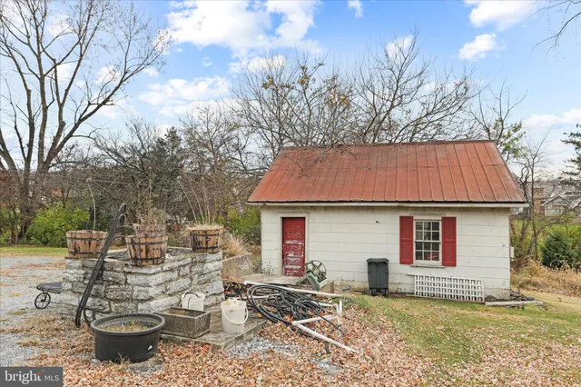 a picture of a room with a white wall and a refrigerator